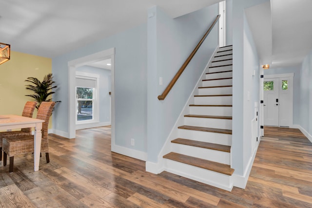 stairs featuring wood-type flooring