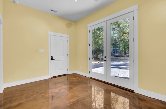 doorway to outside with french doors and concrete flooring