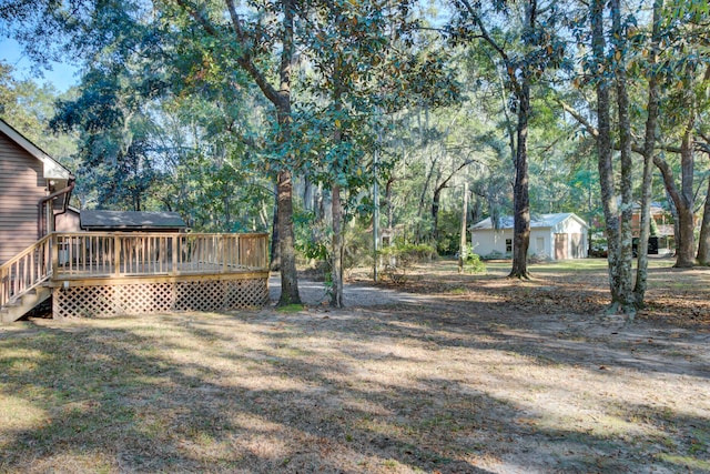 view of yard with a wooden deck