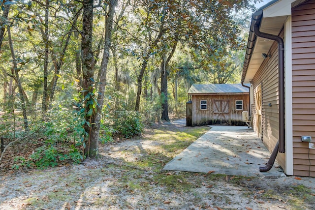 view of yard with a patio area and an outdoor structure