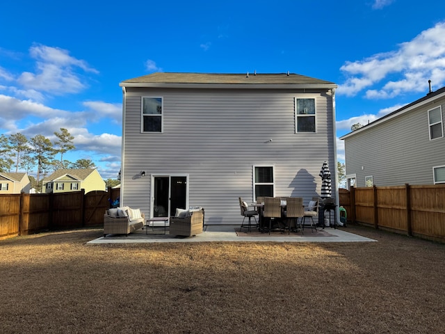 back of property with a patio and an outdoor living space