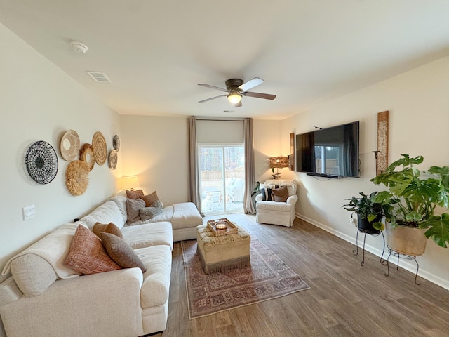 living room with ceiling fan and hardwood / wood-style flooring