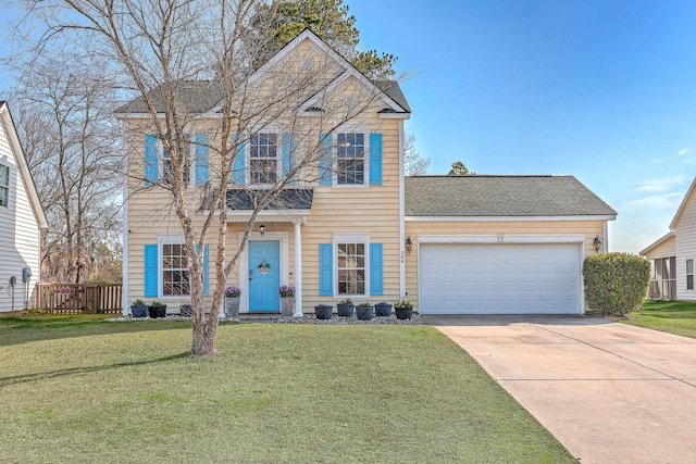 traditional-style home with driveway, a front lawn, an attached garage, and fence