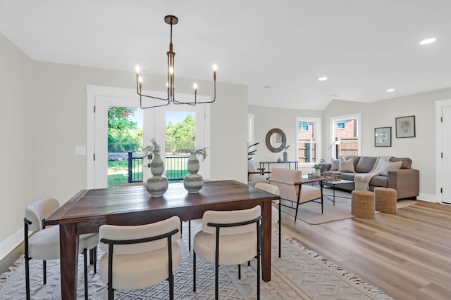 dining room with baseboards, a notable chandelier, light wood-style floors, and recessed lighting
