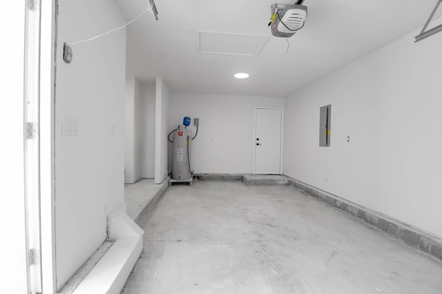 garage with a garage door opener, electric water heater, and electric panel