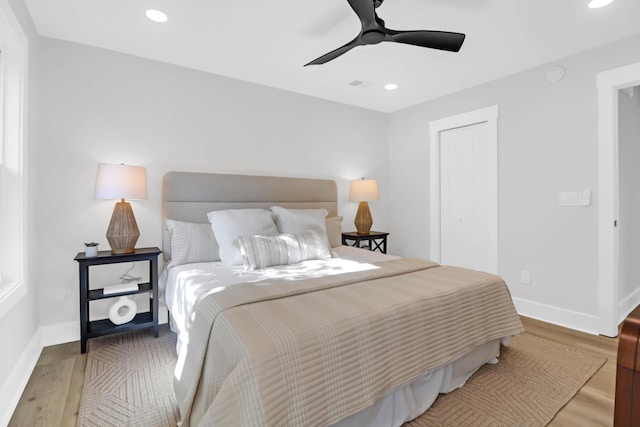 bedroom featuring baseboards, recessed lighting, wood finished floors, a closet, and ceiling fan