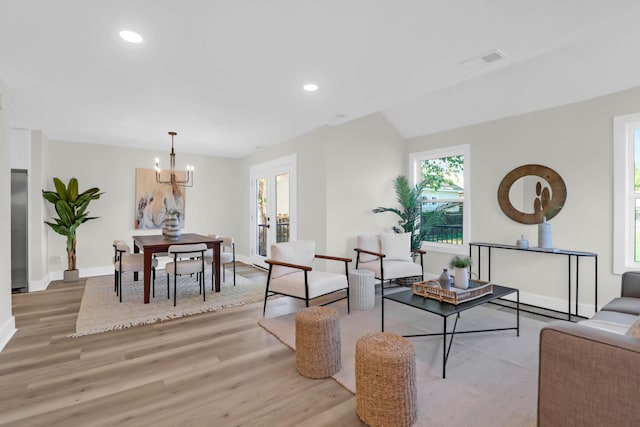 living room featuring recessed lighting, visible vents, light wood-style floors, baseboards, and a notable chandelier