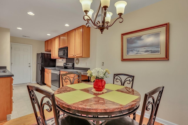 tiled dining space with an inviting chandelier