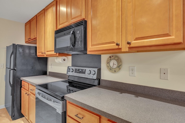 kitchen with light tile patterned floors and black appliances