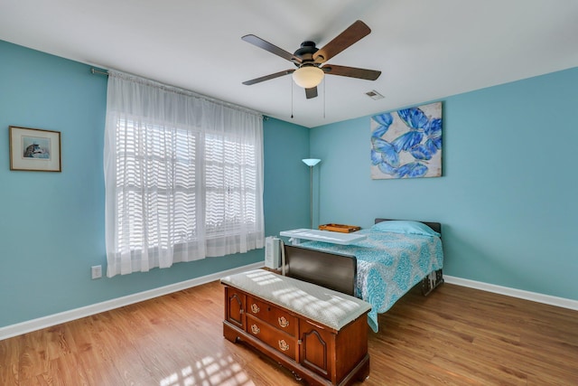 bedroom with ceiling fan and light hardwood / wood-style floors