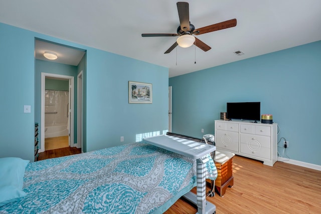 bedroom featuring ensuite bath, ceiling fan, and light hardwood / wood-style floors