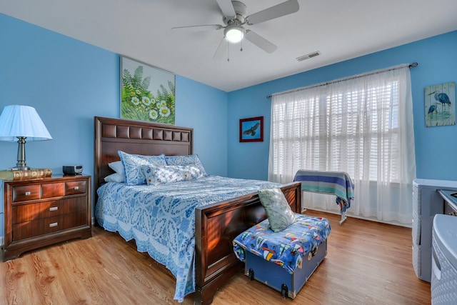 bedroom with ceiling fan and light hardwood / wood-style flooring