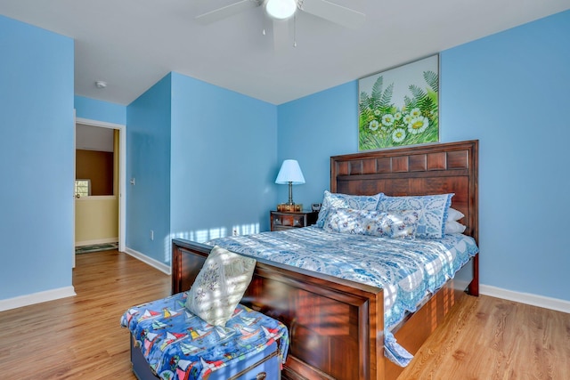 bedroom with ceiling fan and light hardwood / wood-style flooring