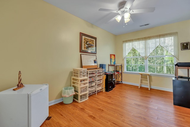 office with ceiling fan and light hardwood / wood-style floors