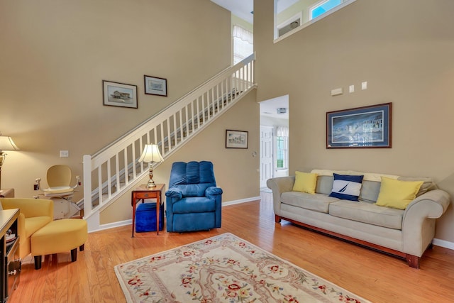 living room featuring a high ceiling and hardwood / wood-style flooring