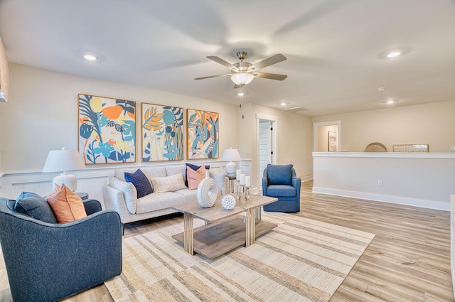 living area featuring ceiling fan, baseboards, wood finished floors, and recessed lighting