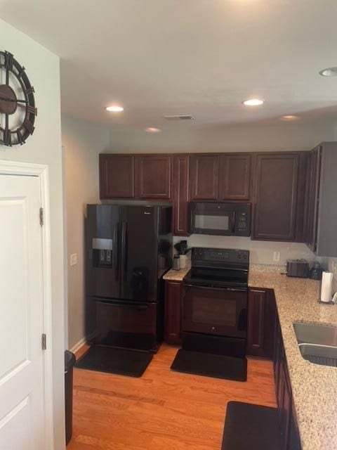 9217 Southern Oak Ln, Ladson, SC 29456 - kitchen featuring black appliances, light wood-type flooring, recessed lighting, a sink, and dark brown cabinetry