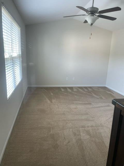 9217 Southern Oak Ln, Ladson, SC 29456 - carpeted spare room featuring baseboards, a ceiling fan, and vaulted ceiling