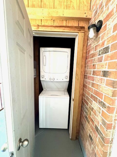 1820 Mepkin Rd Unit 1019, Charleston, SC 29407 - laundry area with estacked washer and dryer and brick wall
