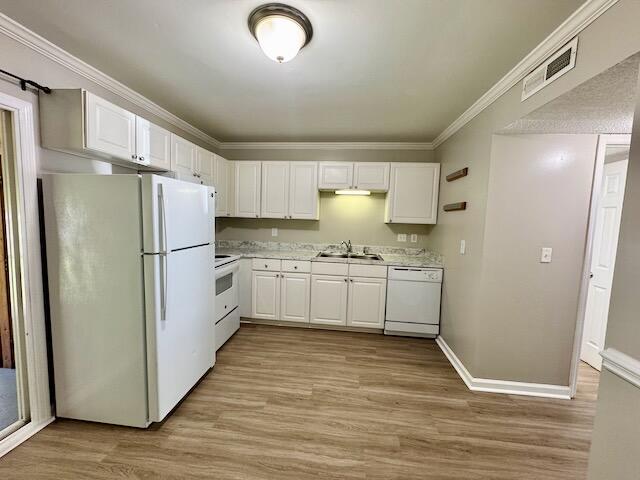 1820 Mepkin Rd Unit 1019, Charleston, SC 29407 - kitchen featuring white appliances, light countertops, white cabinets, light wood-type flooring, and ornamental molding