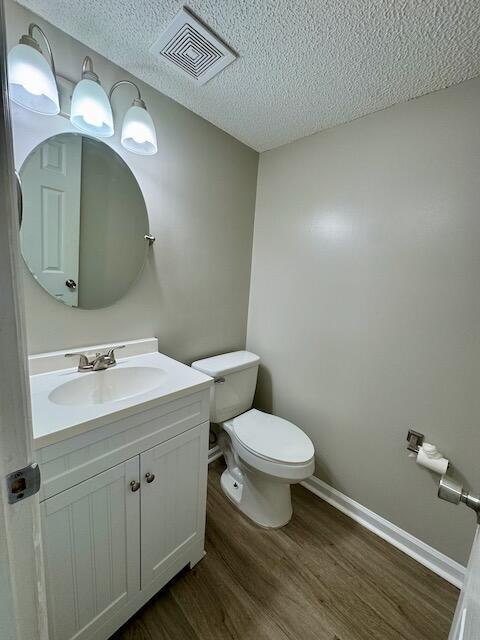 1820 Mepkin Rd Unit 1019, Charleston, SC 29407 - bathroom featuring wood finished floors, vanity, and a textured ceiling