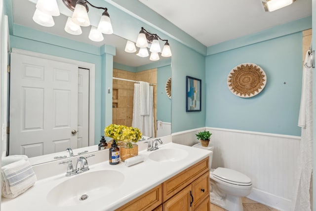 8 Tovey Rd, Charleston, SC 29407 - full bath with wainscoting, double vanity, a tile shower, and tile patterned flooring