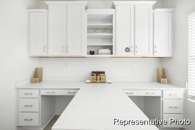 kitchen featuring white cabinets and built in desk