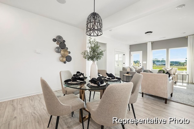 dining area with a notable chandelier and light wood-type flooring