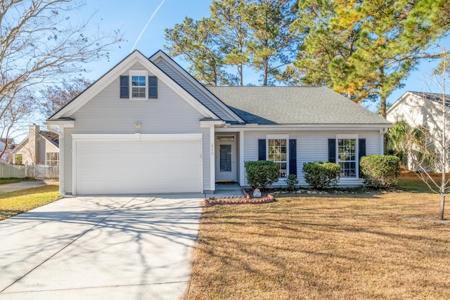 view of front of home with a front yard and a garage