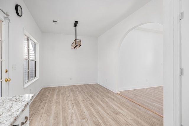 unfurnished dining area with light hardwood / wood-style floors