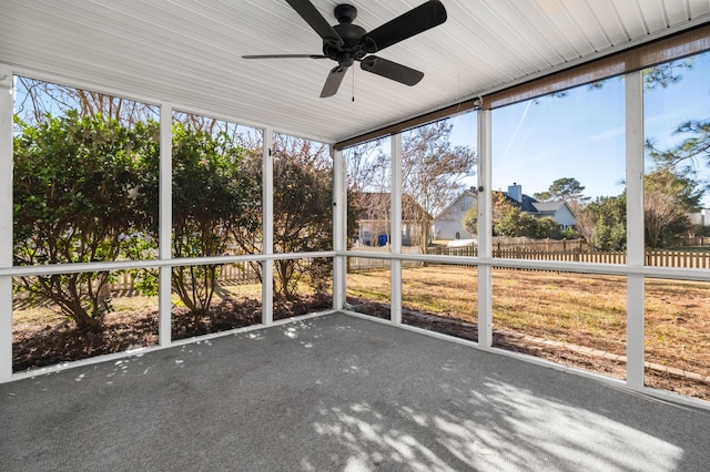 unfurnished sunroom with ceiling fan