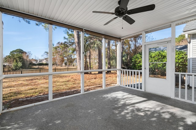 unfurnished sunroom featuring ceiling fan