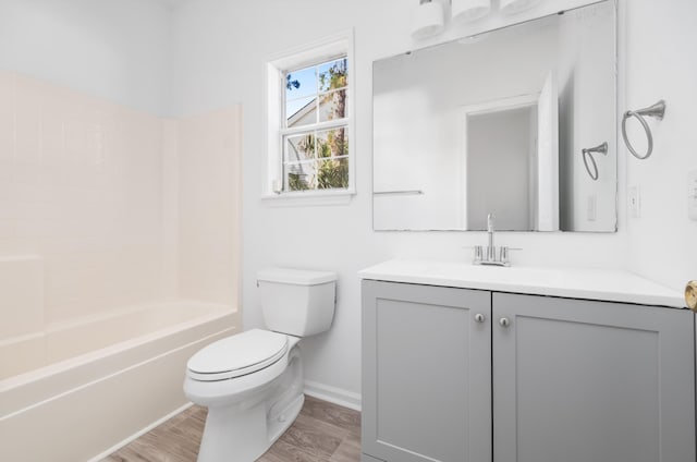 full bathroom with wood-type flooring, vanity, bathing tub / shower combination, and toilet