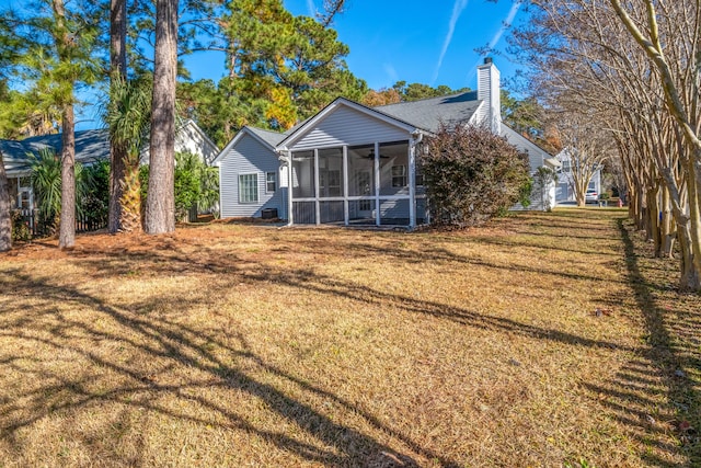 exterior space featuring a sunroom and a yard