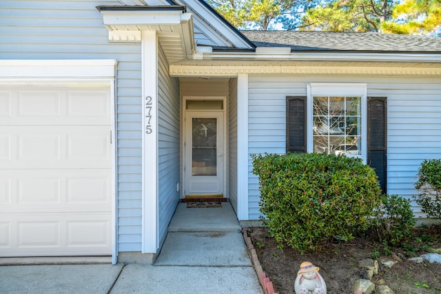 view of exterior entry with a garage