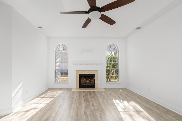 unfurnished living room with light wood-type flooring and ceiling fan