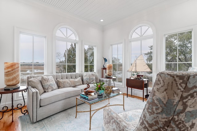 interior space featuring plenty of natural light, crown molding, and light wood-type flooring