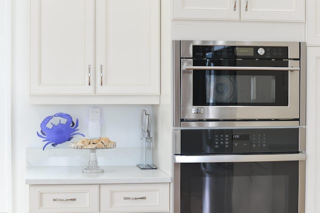 kitchen with white cabinets and stainless steel double oven