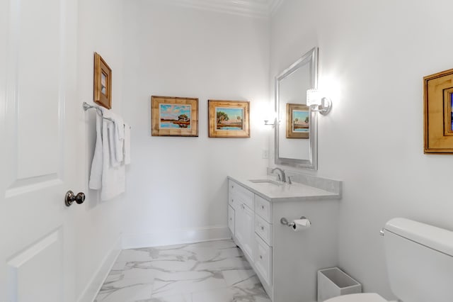 bathroom with toilet, large vanity, tile floors, and crown molding