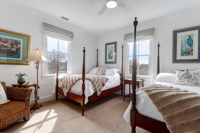 carpeted bedroom featuring ceiling fan and multiple windows