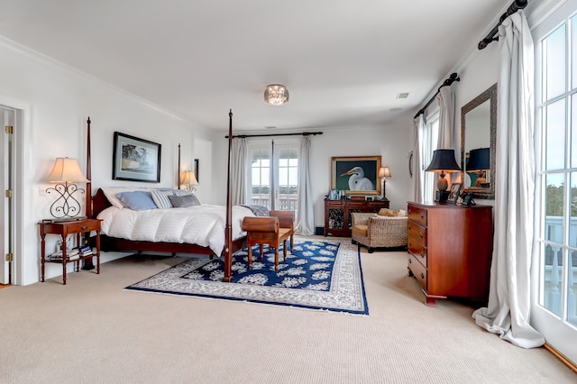 bedroom with ornamental molding and light colored carpet