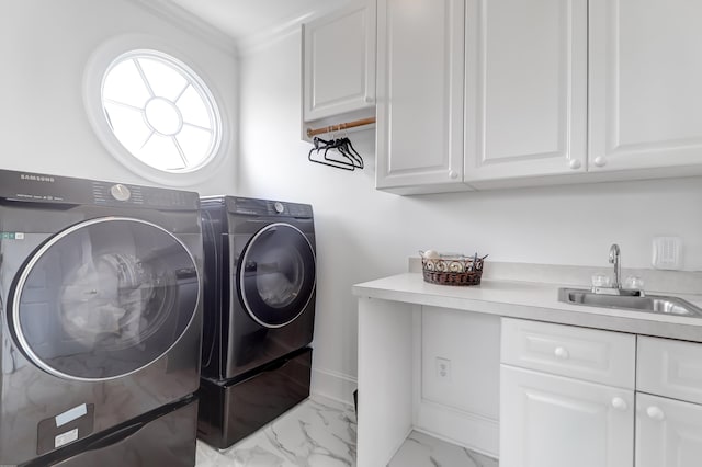 laundry area featuring sink, crown molding, light tile flooring, cabinets, and washing machine and dryer