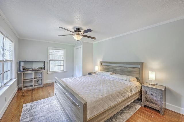1314 Cooper Store Rd, Moncks Corner, SC 29461 - bedroom with a textured ceiling, ornamental molding, wood finished floors, baseboards, and a ceiling fan