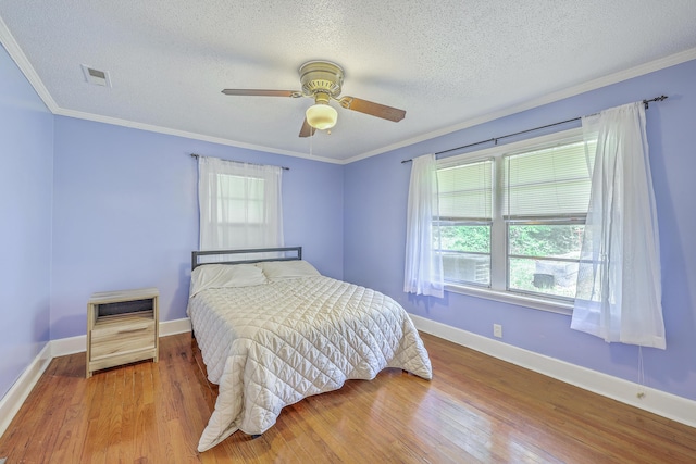 1314 Cooper Store Rd, Moncks Corner, SC 29461 - bedroom featuring wood finished floors, multiple windows, a textured ceiling, baseboards, and ornamental molding