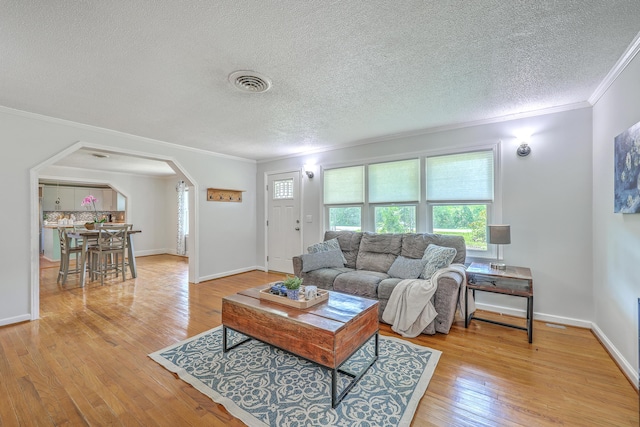 1314 Cooper Store Rd, Moncks Corner, SC 29461 - living room with arched walkways, ornamental molding, light wood-style flooring, a textured ceiling, and baseboards