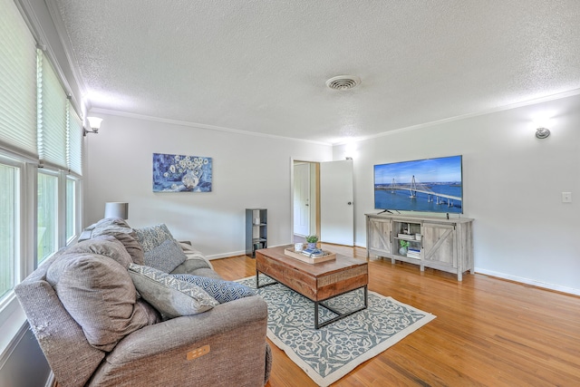 1314 Cooper Store Rd, Moncks Corner, SC 29461 - living room featuring a textured ceiling, ornamental molding, wood finished floors, and baseboards