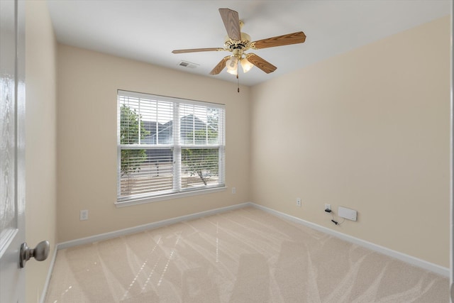 unfurnished room featuring light carpet, a ceiling fan, visible vents, and baseboards