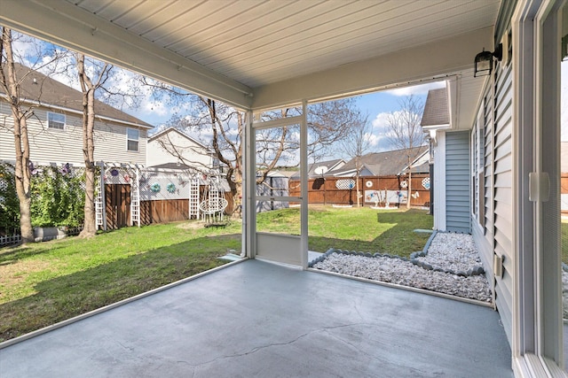 unfurnished sunroom with a residential view and a wealth of natural light