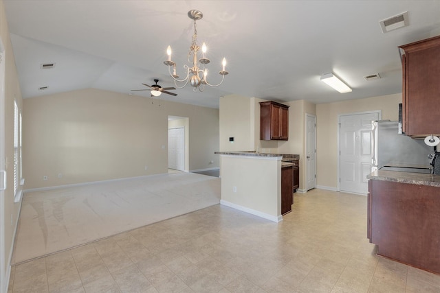 kitchen with open floor plan, lofted ceiling, visible vents, and baseboards