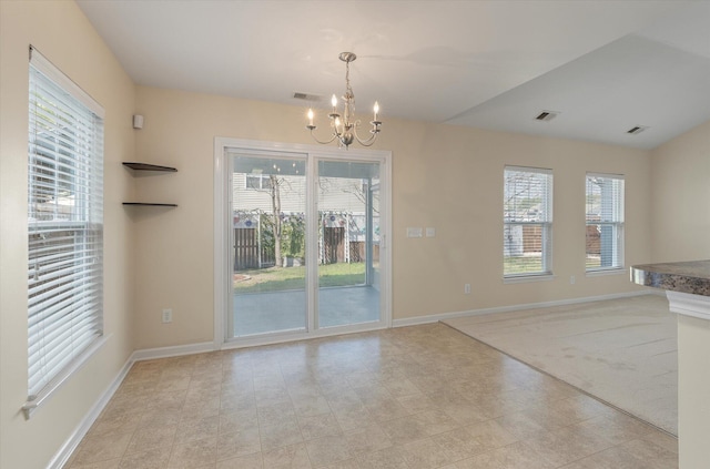 unfurnished dining area with baseboards, visible vents, and an inviting chandelier